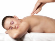 Pretty young woman gets a massage on treatment couch - isolated