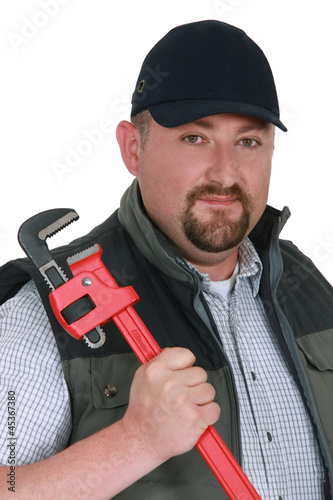 Photo: Portrait of a confident plumber Portrait of a confident plumber