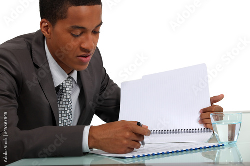 Photo: Businessman reviewing a report Businessman reviewing a report
