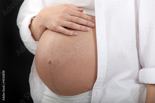 Photo: Woman touching her pregnant belly Woman touching her pregnant belly