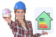 Tradeswoman holding an energy efficiency rating sign