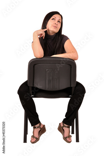 Photo: woman sitting on a chair woman sitting on a chair