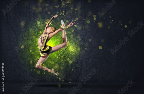 Photo: Young woman in gymnast suit posing Young woman in gymnast suit posing