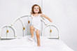 Toddler dancing in bed