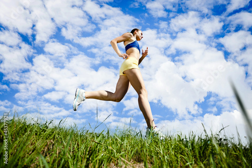 Photo: Young woman running outdoor Young woman running outdoor