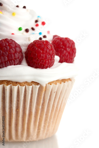 Photo: tasty cupcake with berries, isolated on white tasty cupcake with berries, isolated on white