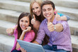 Photo: Friends with laptop showing thumbs up Friends with laptop showing thumbs up