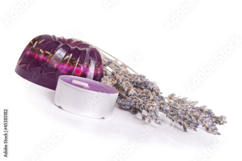 Photo: A handmade lavender soap and a candle isolated on white A handmade lavender soap and a candle isolated on white