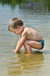 Photo: Child on the bank of the river Child on the bank of the river