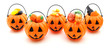 Five jack-o-lantern candy holders filled with a variety of candy