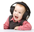 Cute little boy enjoying music using headphones