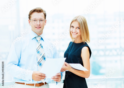 Photo: Two young business collegues. Two young business collegues.