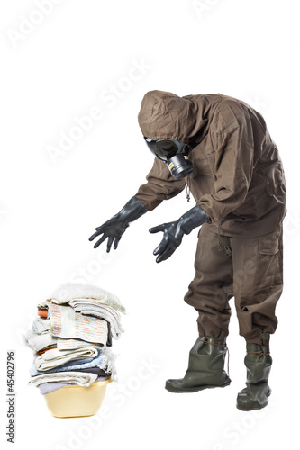 Photo: Man in Hazard Suit looking at dirty laundry Man in Hazard Suit looking at dirty laundry