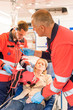 Paramedics in ambulance with patient broken arm