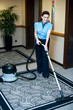 Staff cleaning carpet with a vacuum cleaner