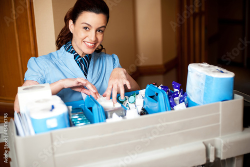 Photo: Working staff arranging toiletries in a wheel cart Working staff arranging toiletries in a wheel cart