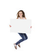 Photo: happy teenage girl jumping while holding a placard happy teenage girl jumping while holding a placard