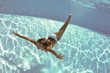 Photo: Underwater woman portrait with white bikini in swimming pool. Underwater woman portrait with white bikini in swimming pool.
