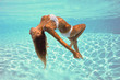 Photo: Underwater woman portrait with white bikini in swimming pool. Underwater woman portrait with white bikini in swimming pool.