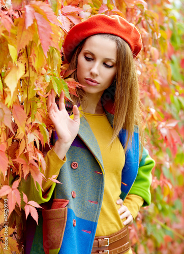 Photo: Fashion woman walking in autumn park Fashion woman walking in autumn park