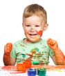 Child is grabbing some paint using fingers