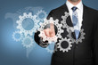 Man with Touchscreen an Cogwheels