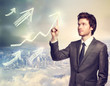 Photo: Businessman pointing rising arrows Businessman pointing rising arrows