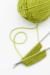 Green knitting wool and knitting needles