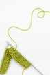 Green knitting wool and knitting needles