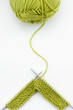 Green knitting wool and knitting needles