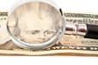 dollars and magnifying glass