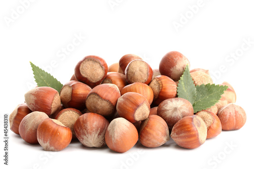 Photo: tasty hazelnuts with leaves, isolated on white tasty hazelnuts with leaves, isolated on white