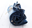 Jeans roll over wooden surface