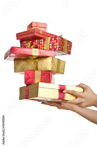 Photo: Hand holding stack of giftboxes Hand holding stack of giftboxes