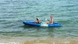 Mother and son kayaking at tropical sea