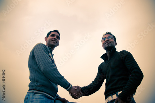 Photo: Shaking hand of indian young happy people Shaking hand of indian young happy people