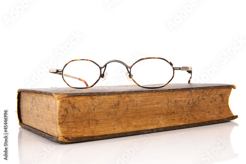Photo: Old book with glasses Old book with glasses