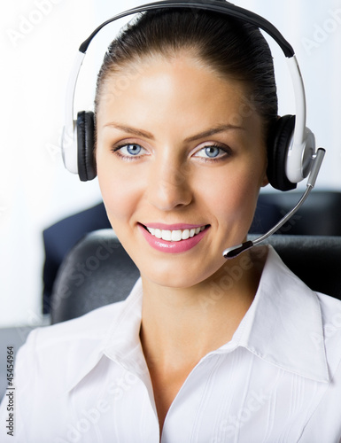 Photo: Portrait of female support phone operator at workplace Portrait of female support phone operator at workplace