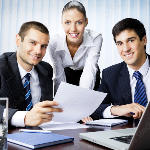 Photo: Three businesspeople working at office Three businesspeople working at office
