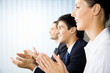 Happy businesspeople applauding at office