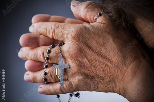 Photo: Praying with a rosary Praying with a rosary