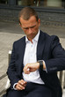Smartly dressed man checking his watch