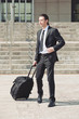 Young businessman with suitcase.