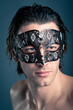 Close up portrait of young man with carnival mask 