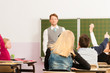 Education - Teacher with pupil in school teaching