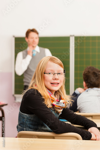 Photo: Education - Teacher with pupil in school teaching Education - Teacher with pupil in school teaching