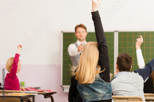 Photo: Education - Teacher with pupil in school teaching Education - Teacher with pupil in school teaching