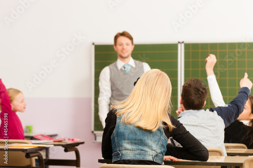 Photo: Education - Teacher with pupil in school teaching Education - Teacher with pupil in school teaching