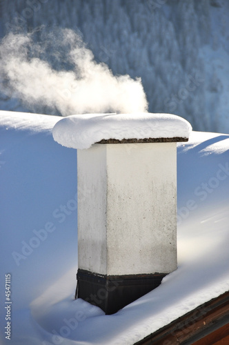 Photo: Smoking chimney of a Swiss cottage Smoking chimney of a Swiss cottage