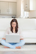Woman happily using laptop